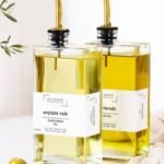 Home Elegant display of olive and sunflower oils in glass bottles with olives, perfect for culinary themes.