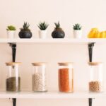 Home Stylish kitchen shelf displaying succulents and jars of legumes for a modern, minimalist look.